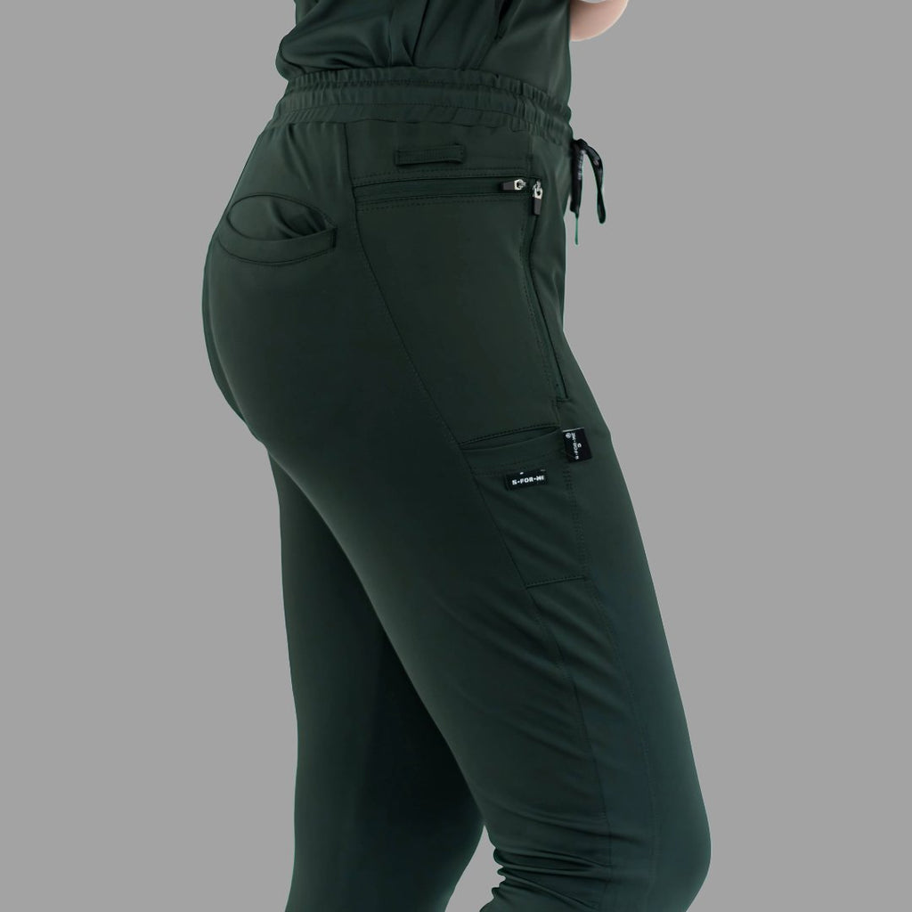 Close-up side view of women's scrub joggers 920 super stretch bottle green showing side cargo pocket.