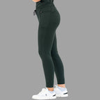 Side profile view of women's scrub joggers 920 super stretch bottle green on a grey background.