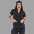 Women's black Style 930 scrub top, front view with hands in pockets