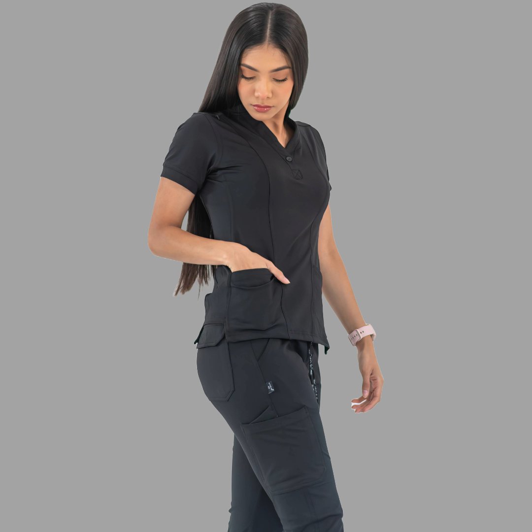 Women's black Style 930 scrub top, side view with hand in pocket