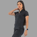 Women's black Style 930 scrub top, three-quarter view with hand on neck